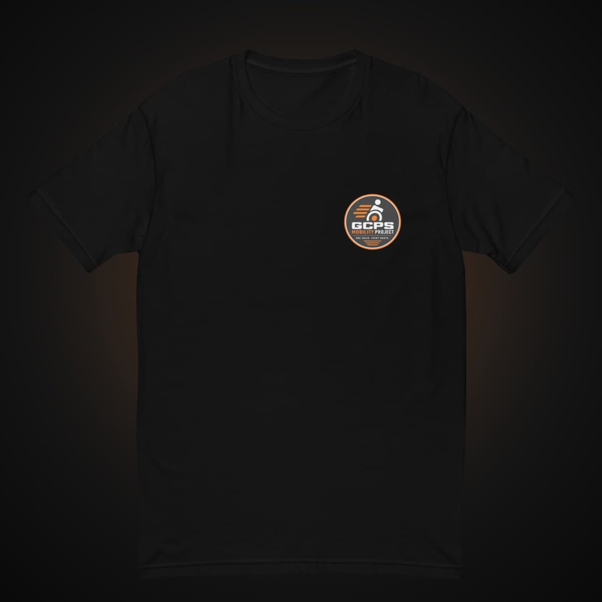Front of the black GCPS Mobility Project T-Shirt with a small GCPS Mobility Project badge on the left chest